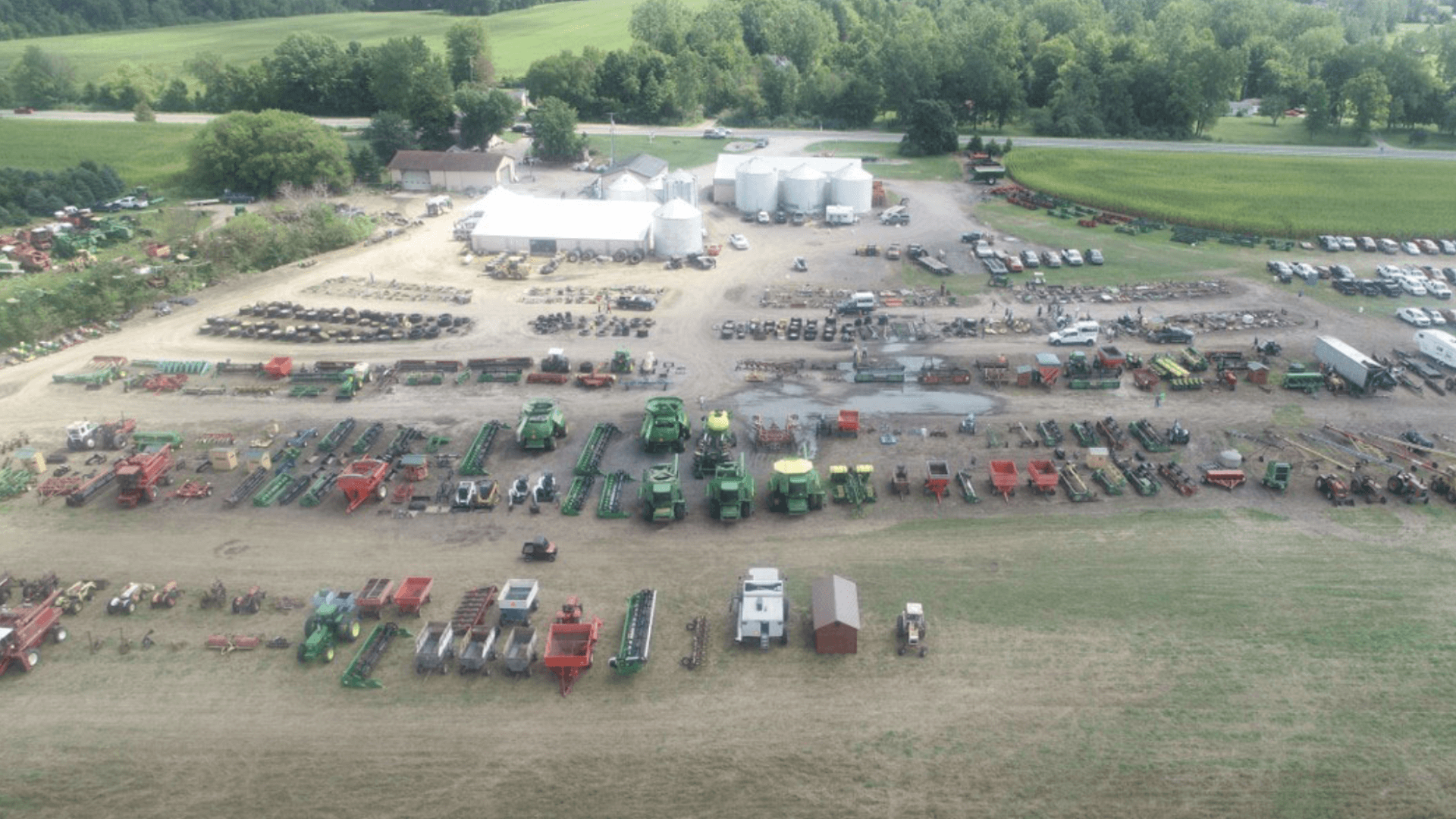 Elmer A. Gross & Sons Auction Yard with rows of equipment for sale.